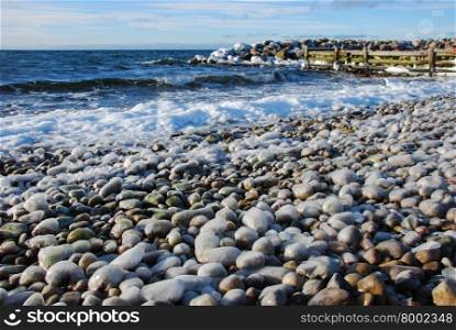 Ice covered pebbles by the coast of the swedish island Oland in the Baltic Sea