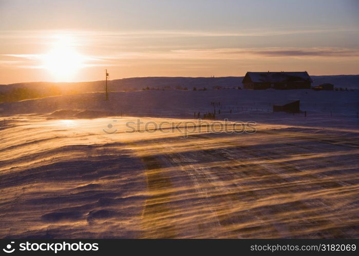 Ice covered road and snowy rural landscape.