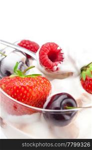 ice cream, cherries, raspberries, strawberries and spoon isolated on white