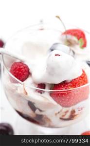 ice cream, cherries, raspberries, strawberries and spoon isolated on white