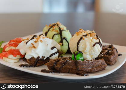 ice cream , chocolate waffles with chocolate sauce and whipping cream