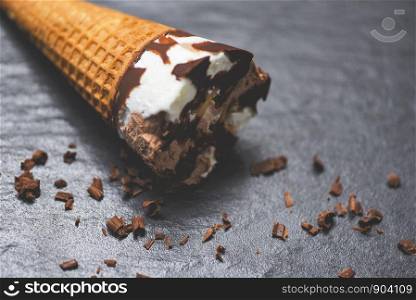 ice cream cone chocolate vanilla on the dark background / ice cream scoops chocolate chunks popsicle and sweet dessert