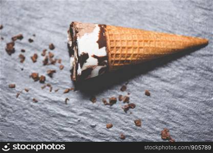 ice cream cone chocolate vanilla on the dark background / ice cream scoops chocolate chunks popsicle and sweet dessert