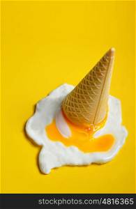 Ice cream cone dropped concept with fried egg