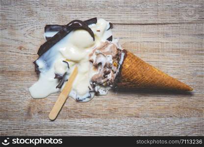 ice cream cone vanilla and ice cream stick with chocolate dripping flowing on dark background , Flat lay / ice cream melting scoops popsicle and sweet dessert