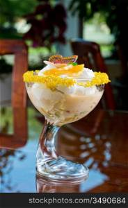 Ice cream dessert with kiwi and orange decorated with butterfly