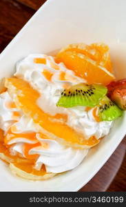 Ice cream dessert with kiwi, strawberry and orange