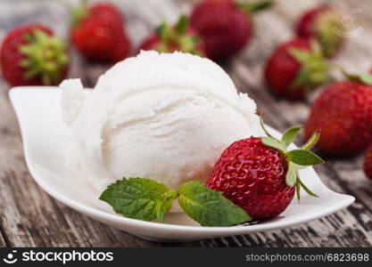 Ice cream. ice cream and strawberries on a wooden table