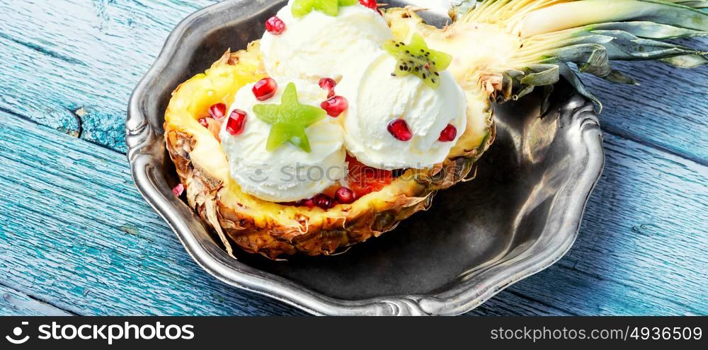 Ice cream in pineapple. Ice cream in a pineapple vase, decorated with kiwi and pomegranate
