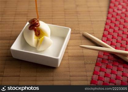 Ice cream mini Mochi with caramel  cajeta . Traditional Japanese dessert made from rice flour. Close up on bamboo surface. 