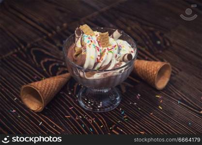 Ice-cream on brown wooden background. Ice-cream on wooden