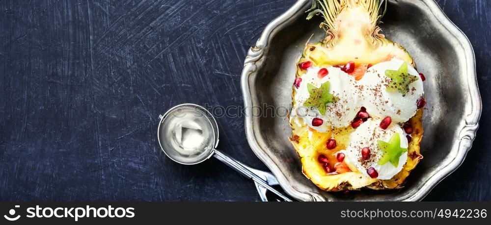 Ice cream pineapple vanilla. Ice cream in pineapple bowl, decorated with kiwi and pomegranate.Icecream dessert