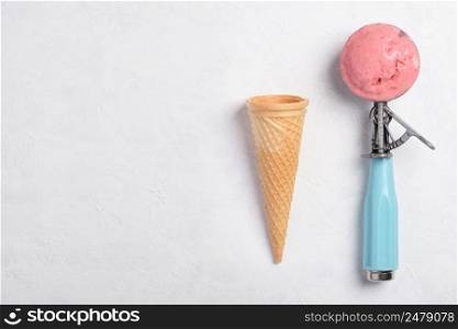Ice cream spoon with homemade icecram scoop with wafer cone on white table background topview flatlay with copy space