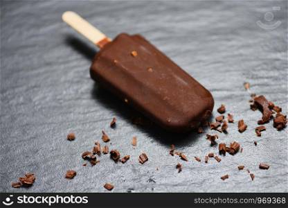 ice cream stick with nut almonds on dark background , Flat lay / ice cream covered chocolate sticks frozen Popsicle and Lolly sweet dessert