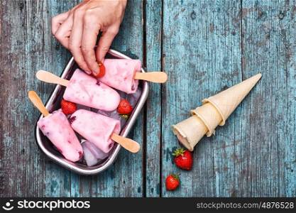 Ice cream with berries. process of decorating with berries dessert ice cream