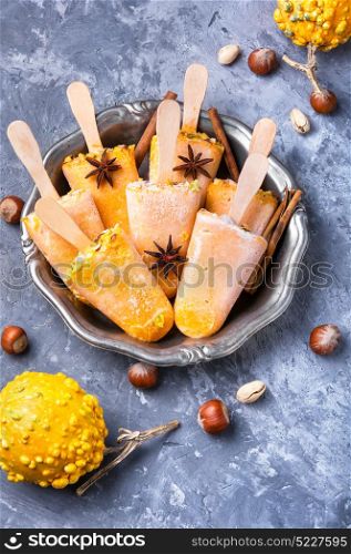 ice cream with pumpkin and nuts. autumn ice cream with pumpkin taste, cinnamon and hazelnut