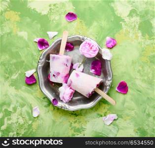Ice-cream with taste of a tea rose. Summer vanilla ice cream with fresh rose flowers