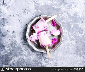 Ice-cream with taste of a tea rose. Summer vanilla ice cream with fresh rose flowers