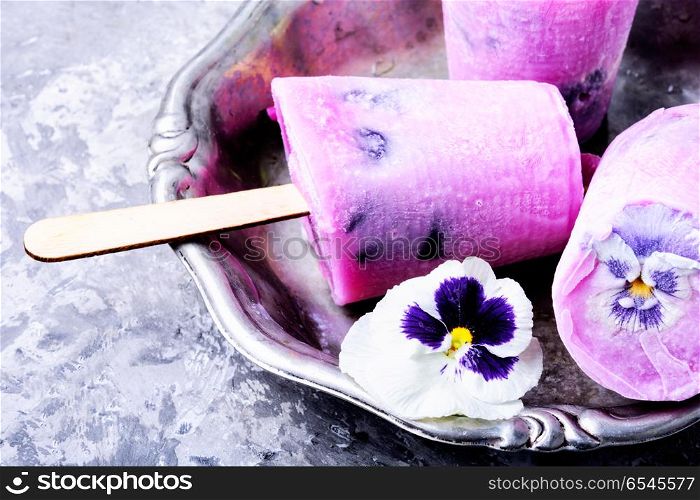 Ice cream with taste of flowers. Summer vanilla ice cream with fresh flowers