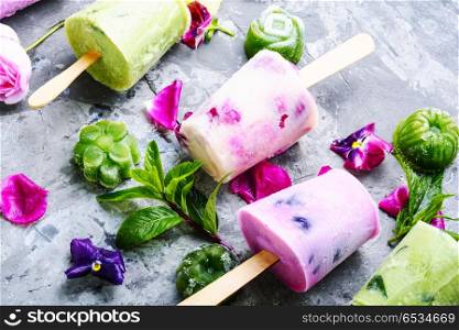 Ice cream with taste of flowers. Summer vanilla ice cream with fresh flowers and mint