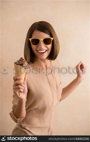 Ice cream woman singing in cone like in microphone happy, joyful and cheerful. Cute young female model eating ice cream cone