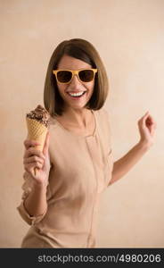 Ice cream woman singing in cone like in microphone happy, joyful and cheerful. Cute young female model eating ice cream cone