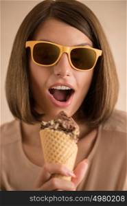 Ice cream woman singing in cone like in microphone happy, joyful and cheerful. Cute young female model eating ice cream cone