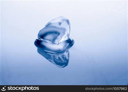 Ice cube melts in studio: Global warming concept