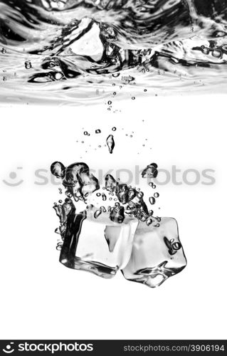 ice cubes dropped into water with splash isolated on white