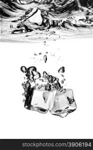 ice cubes dropped into water with splash isolated on white