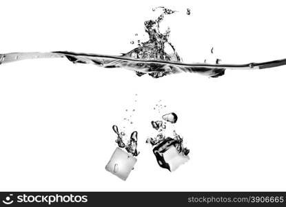 ice cubes dropped into water with splash isolated on white