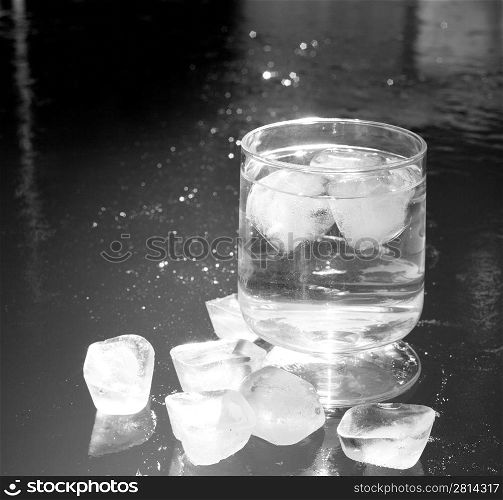 ice cubes on an iced water surface and cup glass