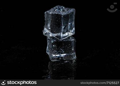 ice cubes on black isolated glass background