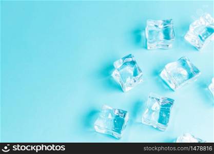 Ice cubes on blue background, Cubes of ice on a light blue background, Flat lay, top view, with copy space and field for text.