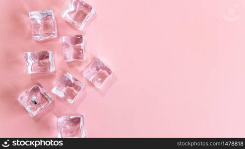 Ice cubes on pink background, Cubes of ice on a light pink background, Flat lay, top view, with copy space and field for text.