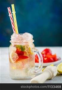 Ice fizzy Strawberry lemonade with mint and lemon in Mason jar