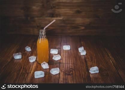 Ice fresh juice with ice cubes on table. Picture decorate any interior of bar, kitchen, cafe and many other premises. Ice fresh juice with ice cubes on table