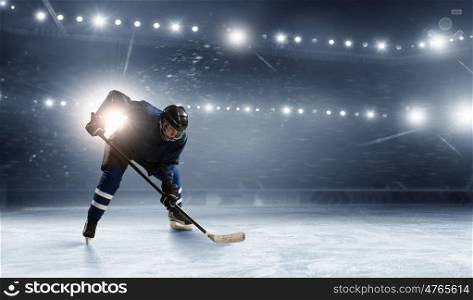 Ice hockey player at rink. Hockey player in lights at ice rink