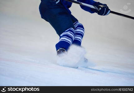 ice hockey player in action kicking with stick