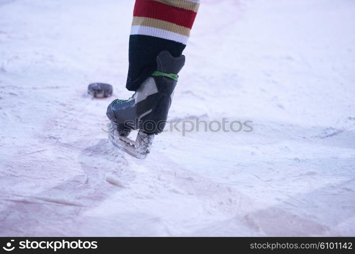 ice hockey player in action kicking with stick