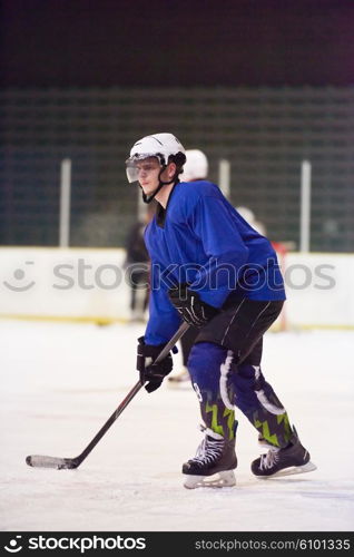 ice hockey player in action kicking with stick