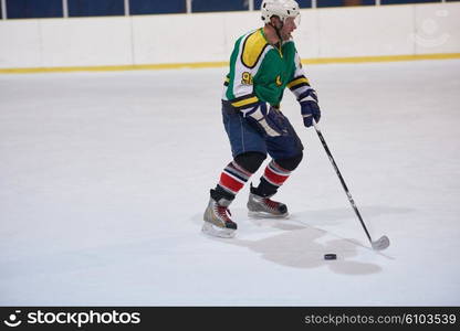 ice hockey player in action kicking with stick