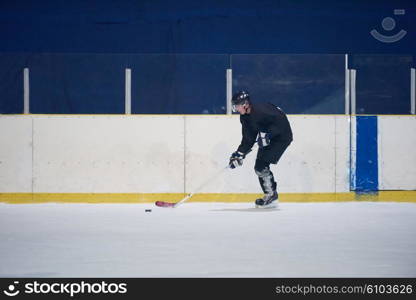 ice hockey player in action kicking with stick