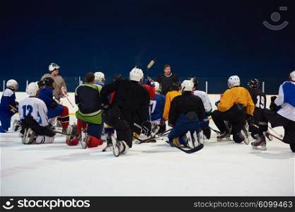 ice hockey players team group meeting with trainer in sport arena indoors