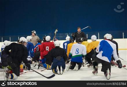ice hockey players team group meeting with trainer in sport arena indoors