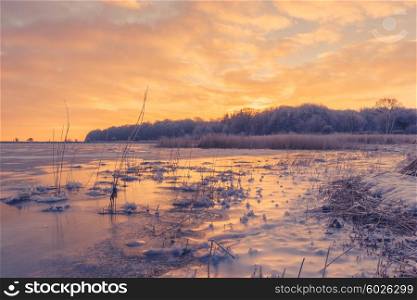 Ice on a lake in a beautiful sunrise at wintertime