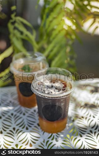 Ice tea in plastic cup put on table