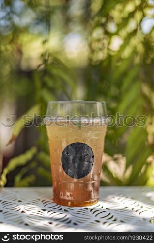 Ice tea in plastic cup put on table