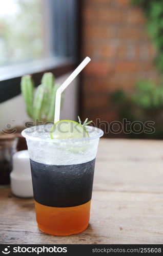 Ice tea with honey and lemon on wooden table