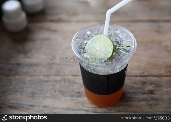 Ice tea with honey and lemon on wooden table